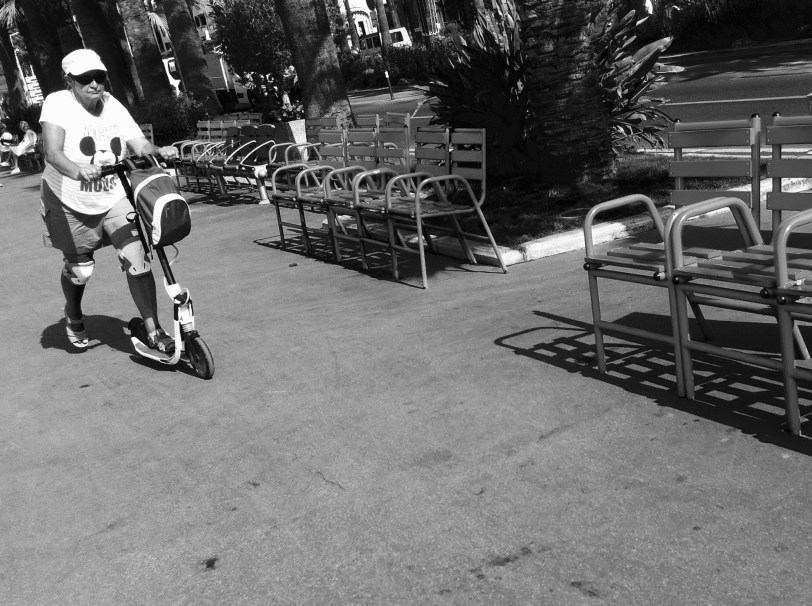 a woman on a scooter on la croisette in Cannes photograph by Paul Conneally