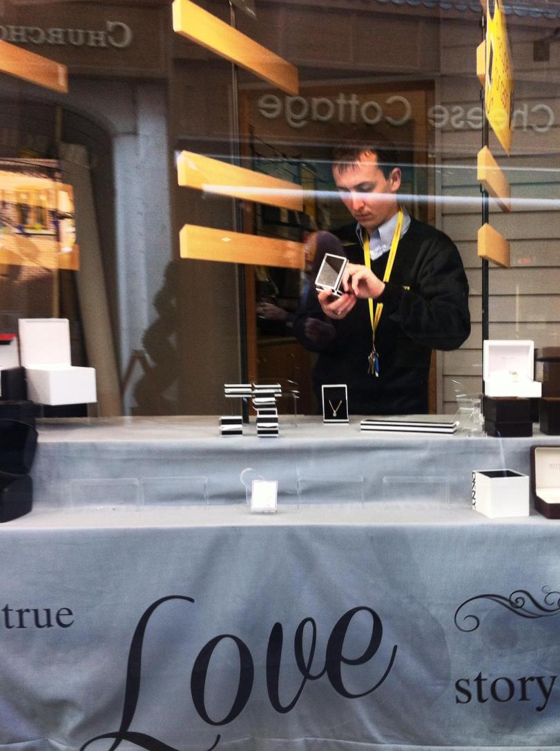 Pawn shop jewellery - shop assistant in shop window - Loughborough - Paul Conneally May 2017